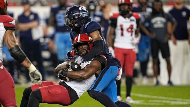 Aug 20, 2022; Toronto, Ontario, CAN; Toronto Argonauts linebacker Wynton McManis (48) tackles Calgary Stampeders running back Dedrick Mills (34) during the second half at BMO Field. Mandatory Credit: John E. Sokolowski-USA TODAY Sports